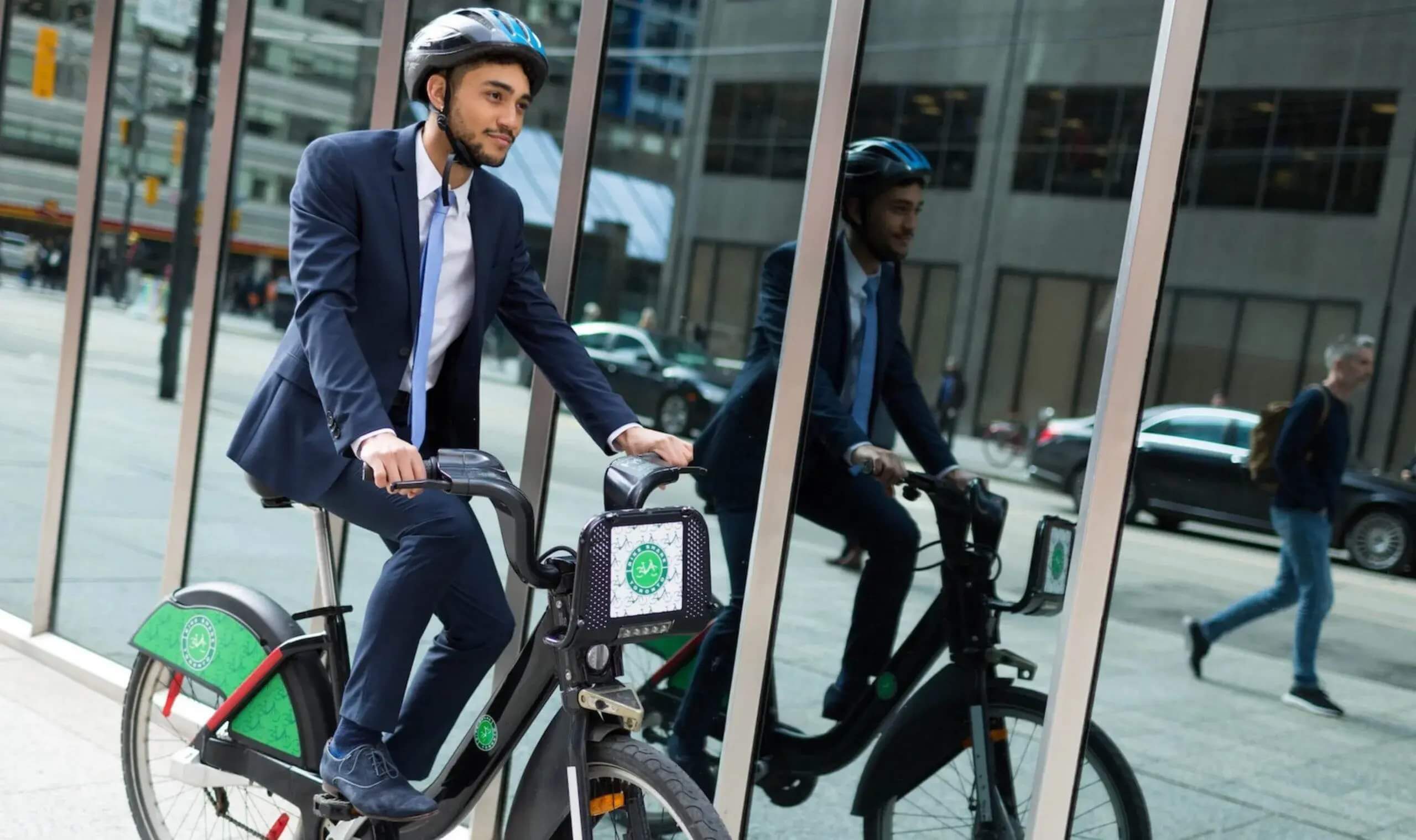 man on a bike wearing a suit